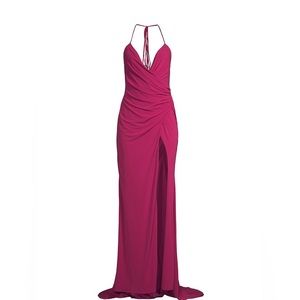 Gorgeously draped halter gown featuring a plunging neckline, thigh-high slit.